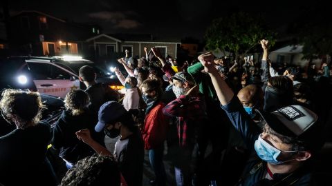 Protesters gather in front of Los Angeles County Sheriff's deputies on Monday night.