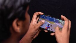 In this photo illustration, a boy is playing PUBG (PlayerUnknown's Battlegrounds) on his smartphone. Indian government is considering a ban on the battle royale format games over data security concerns. (Photo Illustration by Ajay Kumar/SOPA Images/LightRocket via Getty Images)