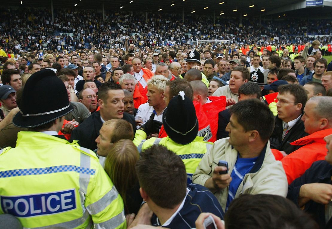Local hero and Leeds United striker Alan Smith (center) is mobbed as thousands invade the pitch at Elland Road following the club's 2004 relegation.