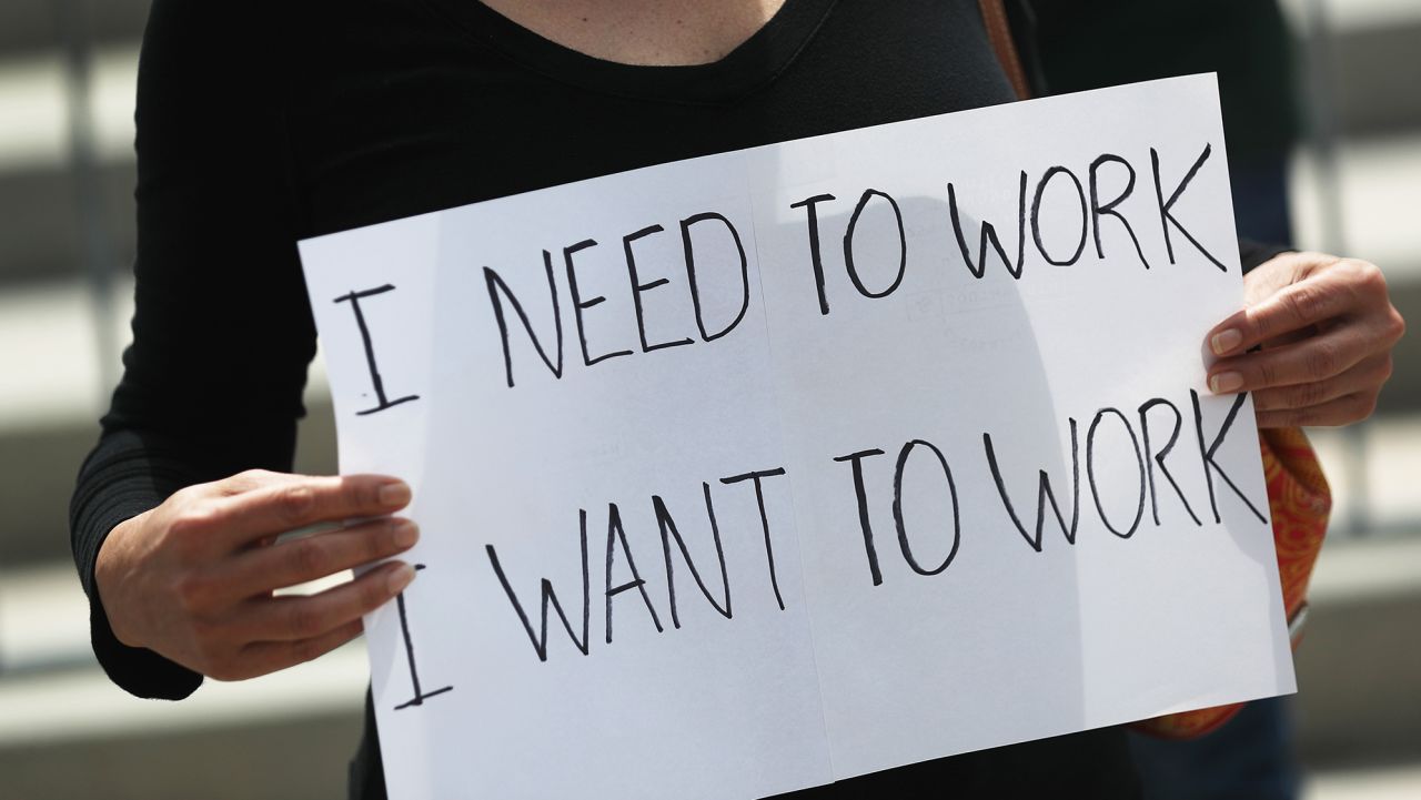 A protester holds a sign that reads, 'I need to work, I want to work,' as she joins with restaurant owners, workers and supporters to protest new measures stating restaurants must close their indoor seating to combat the rise in coronavirus cases on July 10, 2020 in Miami, Florida. Restaurant owners in Miami-Dade County say county Mayor Carlos Gimenez's decision to close restaurant dining halls amid the surge in COVID-19 cases is unfair to them as other businesses stay open. Protest organizers claim there is no clear evidence that closing them is part of a realistic plan that will effectively manage the current crisis in the spread of COVID and they should be able to stay open. (Photo by Joe Raedle/Getty Images)