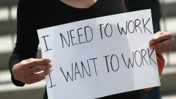 A protester holds a sign that reads, 'I need to work, I want to work,' as she joins with restaurant owners, workers and supporters to protest new measures stating restaurants must close their indoor seating to combat the rise in coronavirus cases on July 10, 2020 in Miami, Florida. Restaurant owners in Miami-Dade County say county Mayor Carlos Gimenez's decision to close restaurant dining halls amid the surge in COVID-19 cases is unfair to them as other businesses stay open. Protest organizers claim there is no clear evidence that closing them is part of a realistic plan that will effectively manage the current crisis in the spread of COVID and they should be able to stay open. (Photo by Joe Raedle/Getty Images)
