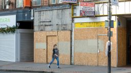 A pedestrian passes underneath estate agents to let and for sale advertising board above empty shops in Croydon, Greater London, U.K., on Monday, Aug. 17, 2020. 