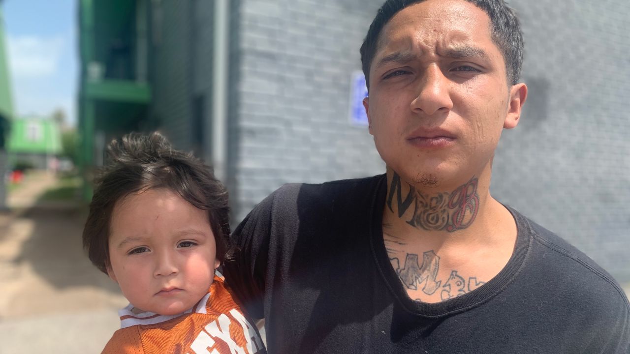 Israel Rodriguez, 24, holds his 20-month-old son, also named Israel