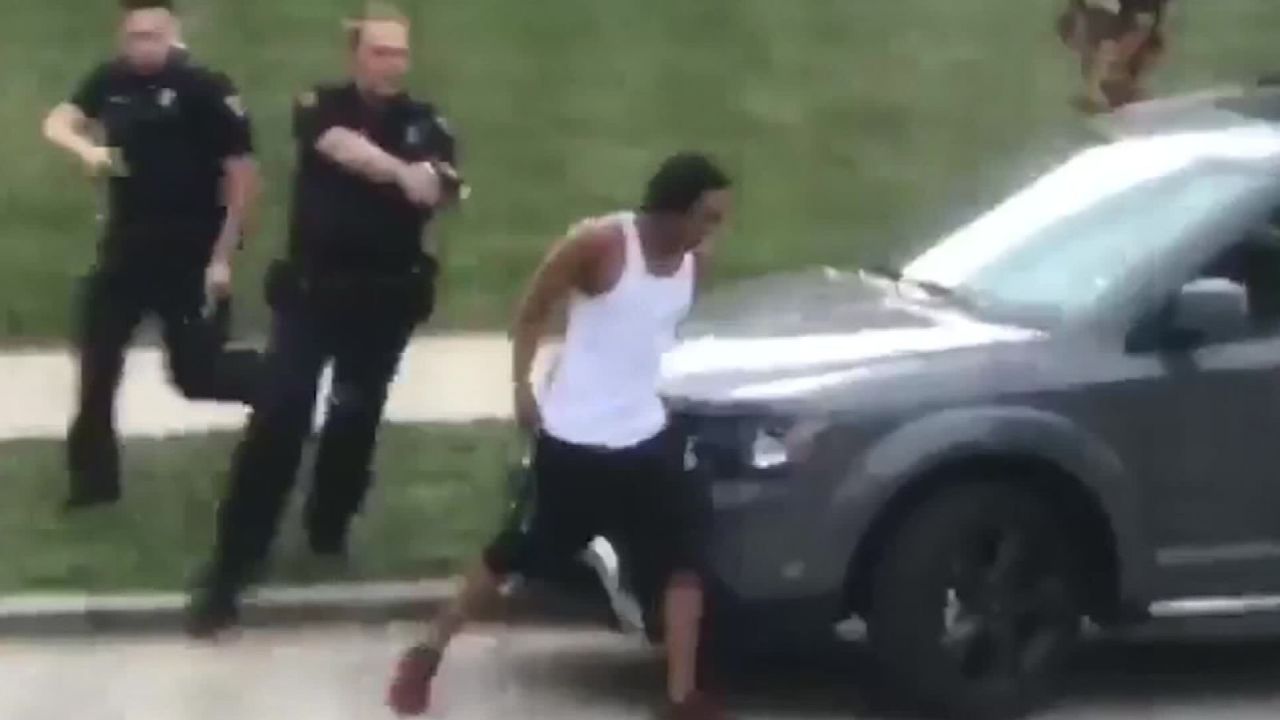 In this screengrab taken from video, police follow Jacob Blake as he walks to the driver's side door of an SUV on August 23. He was shot moments later.