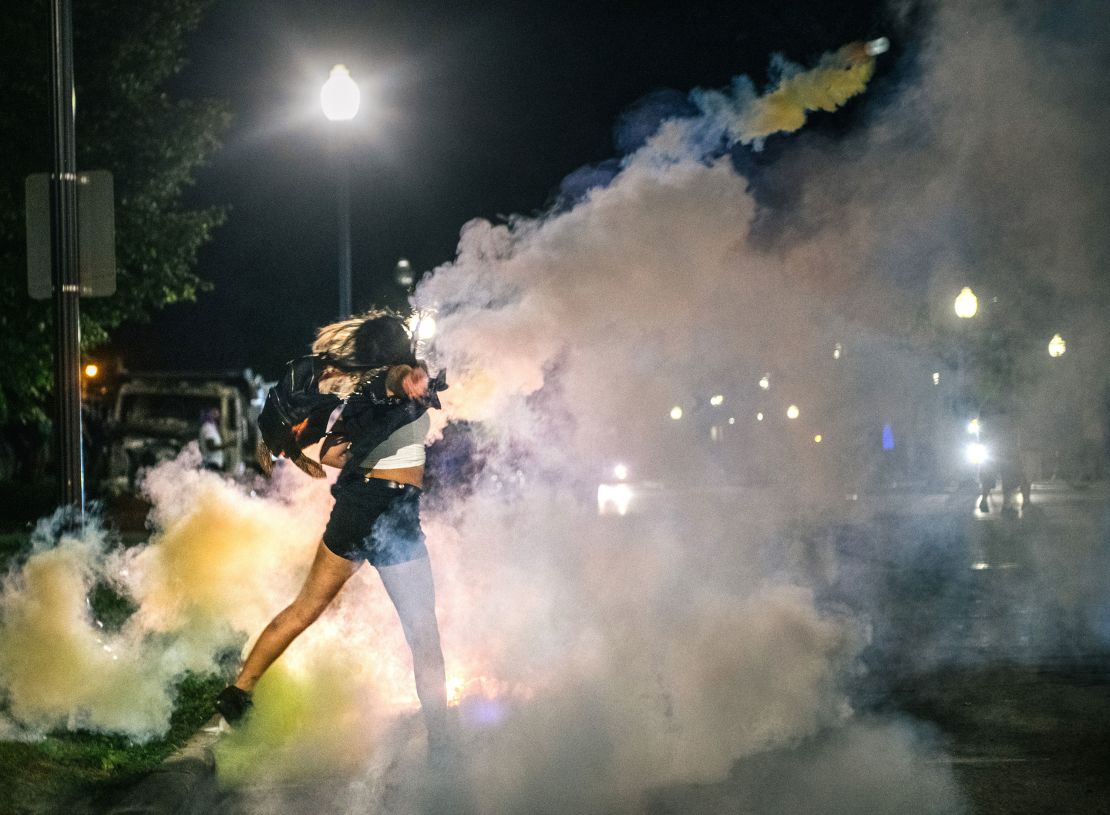 A demonstrator throws back a can of Tear gas on August 25 in Kenosha. 