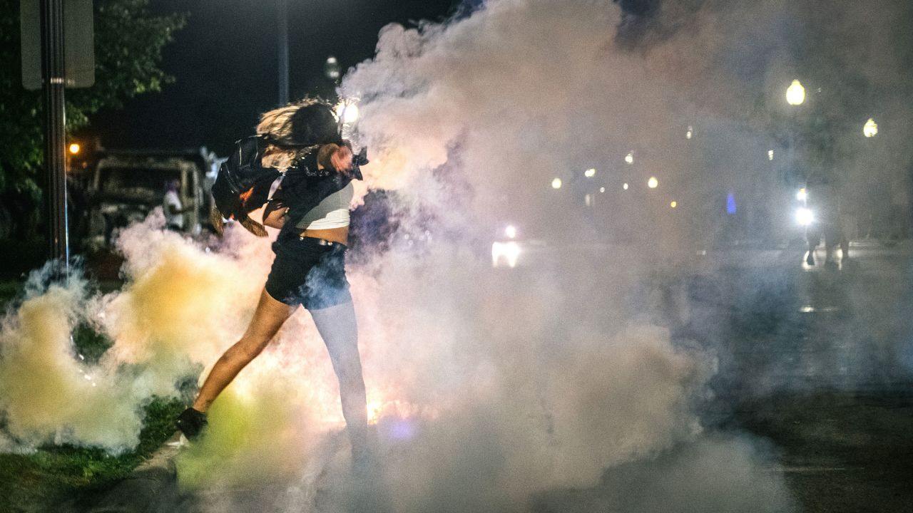 A demonstrator throws back a can of Tear gas on August 25 in Kenosha.