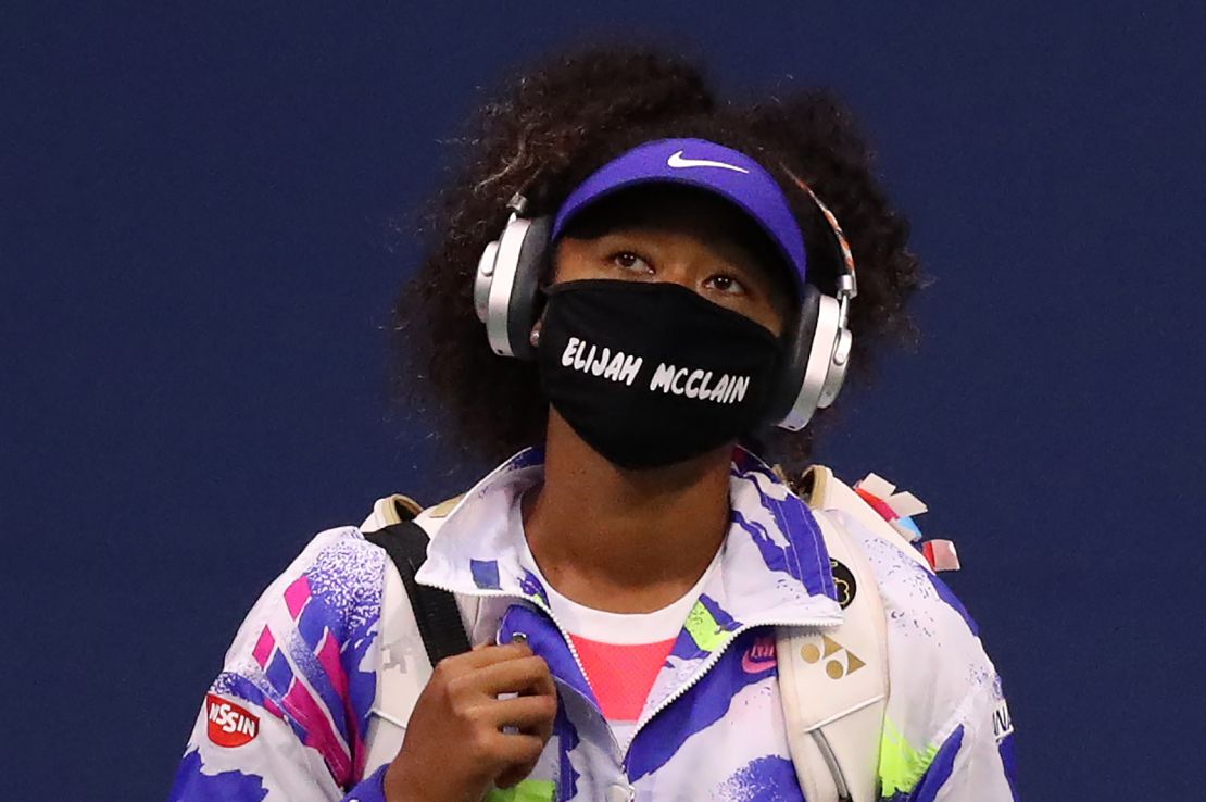 Naomi Osaka walks in wearing a mask with the name Elijah McClain on it before her second round US Open match.