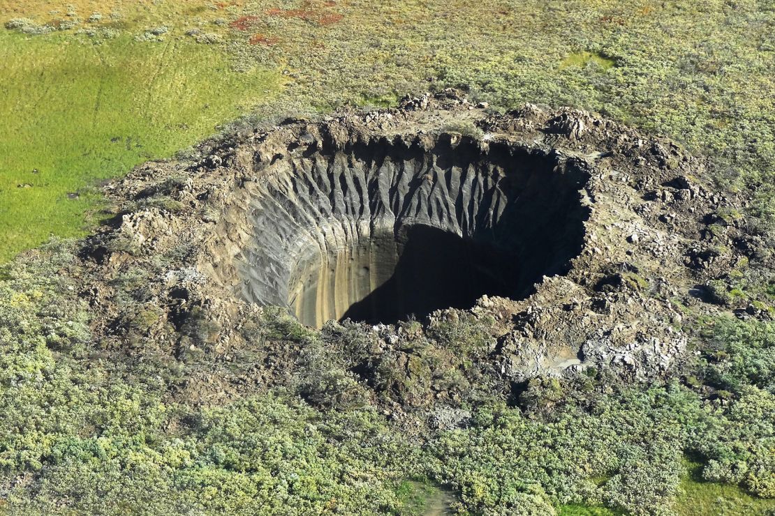 An aerial view taken from a helicopter on August 25, 2014, shows a crater on the Yamal Peninsula, northern Siberia. It was the first to be discovered in 2013. 