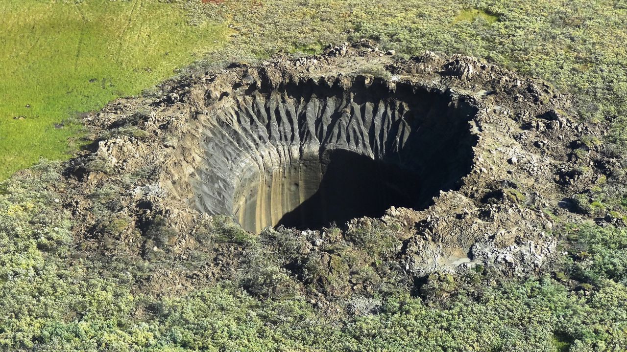 An aerial view taken from a helicopter on August 25, 2014, shows a crater on the Yamal Peninsula, northern Siberia. It was the first to be discovered in 2013.
