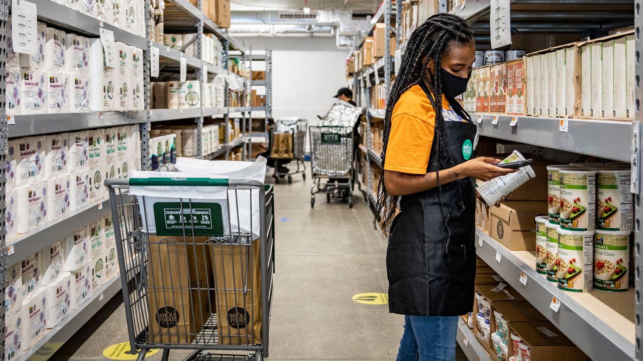 Whole Foods workers stock and pick items off shelves in the store and then Amazon drivers deliver them to customers in the Brooklyn area. 
