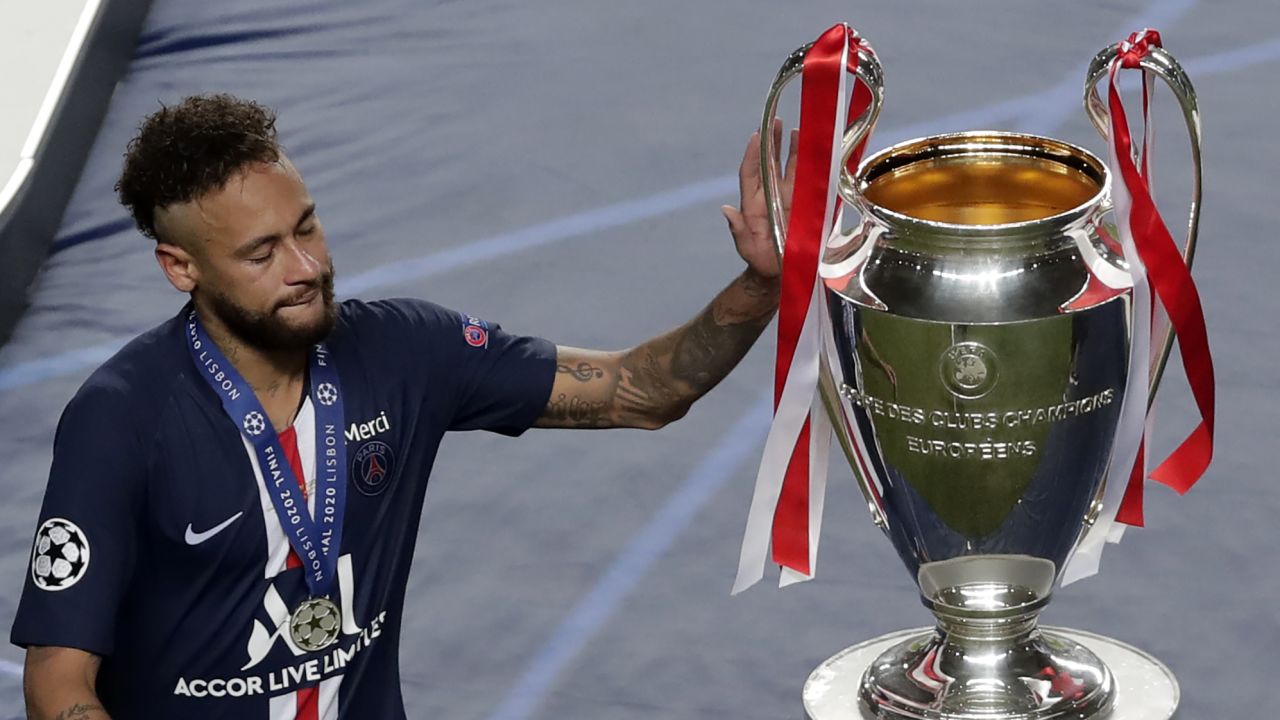 Neymar touches the Champions League trophy after losing in the  final to Bayern Munich.