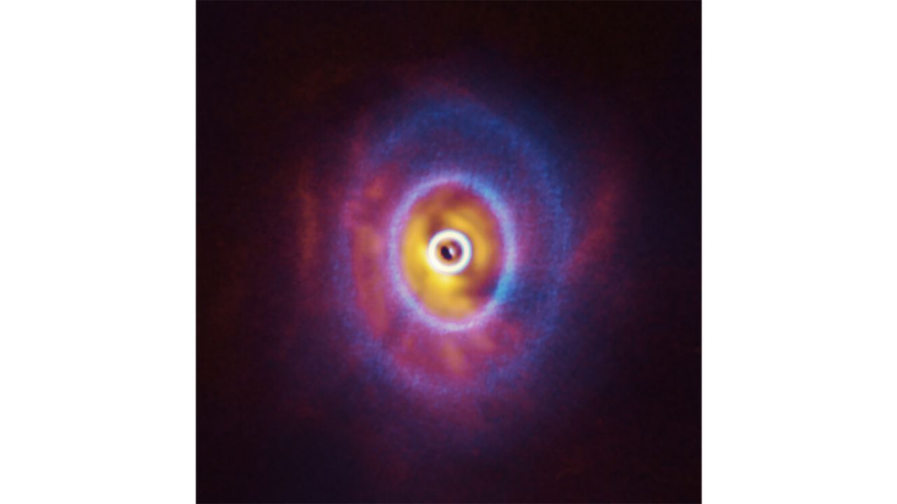 This composite image shows both the ALMA and SPHERE observations of the disk, including the rings. 