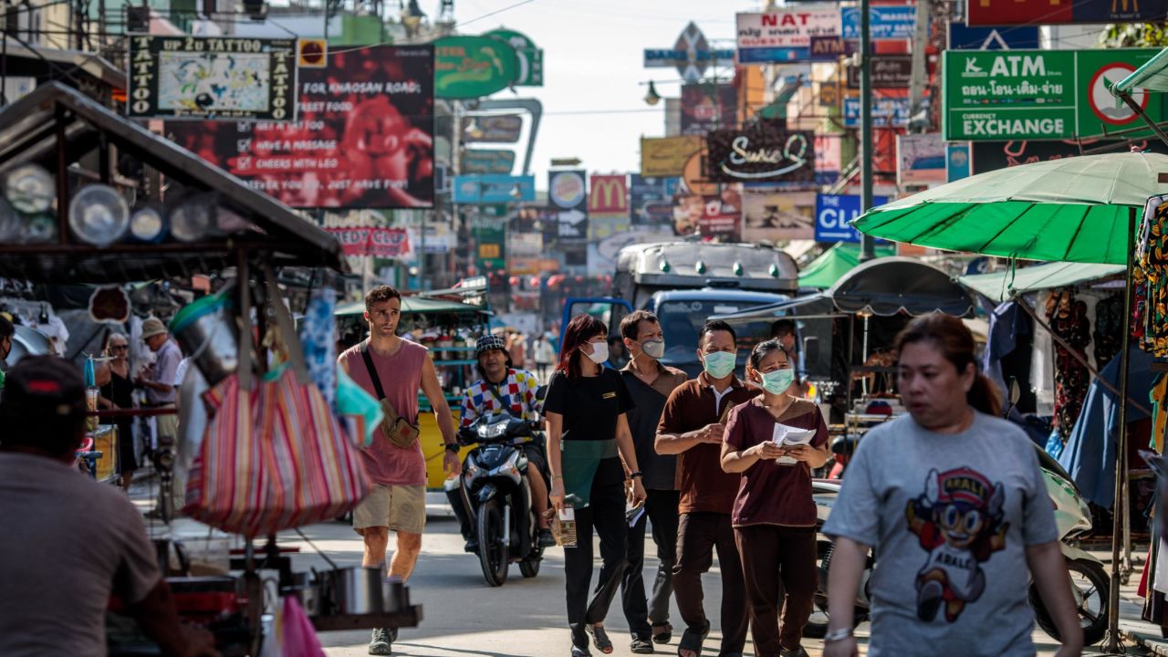 TOPSHOT - People wear facemasks amid concerns over the spread of the COVID-19 novel coronavirus while walking along Khao San Road, a popular area for tourists in Bangkok on March 6, 2020. (Photo by Jack Taylor / AFP) (Photo by JACK TAYLOR/AFP via Getty Images)