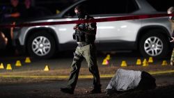 Police walk past evidence markers at the scene where a man suspected of fatally shooting a supporter of a right-wing group in Portland, Ore., last week was killed as investigators moved in to arrest him in Lacey, Wash., Thursday, Sept. 3, 2020. Michael Reinoehl, 48, was killed as a federal task force attempted to apprehend him, a senior Justice Department official said. Reinoehl was the prime suspect in the killing of 39-year-old Aaron "Jay" Danielson, who was shot in the chest Saturday night, the official said. (AP Photo/Ted Warren)