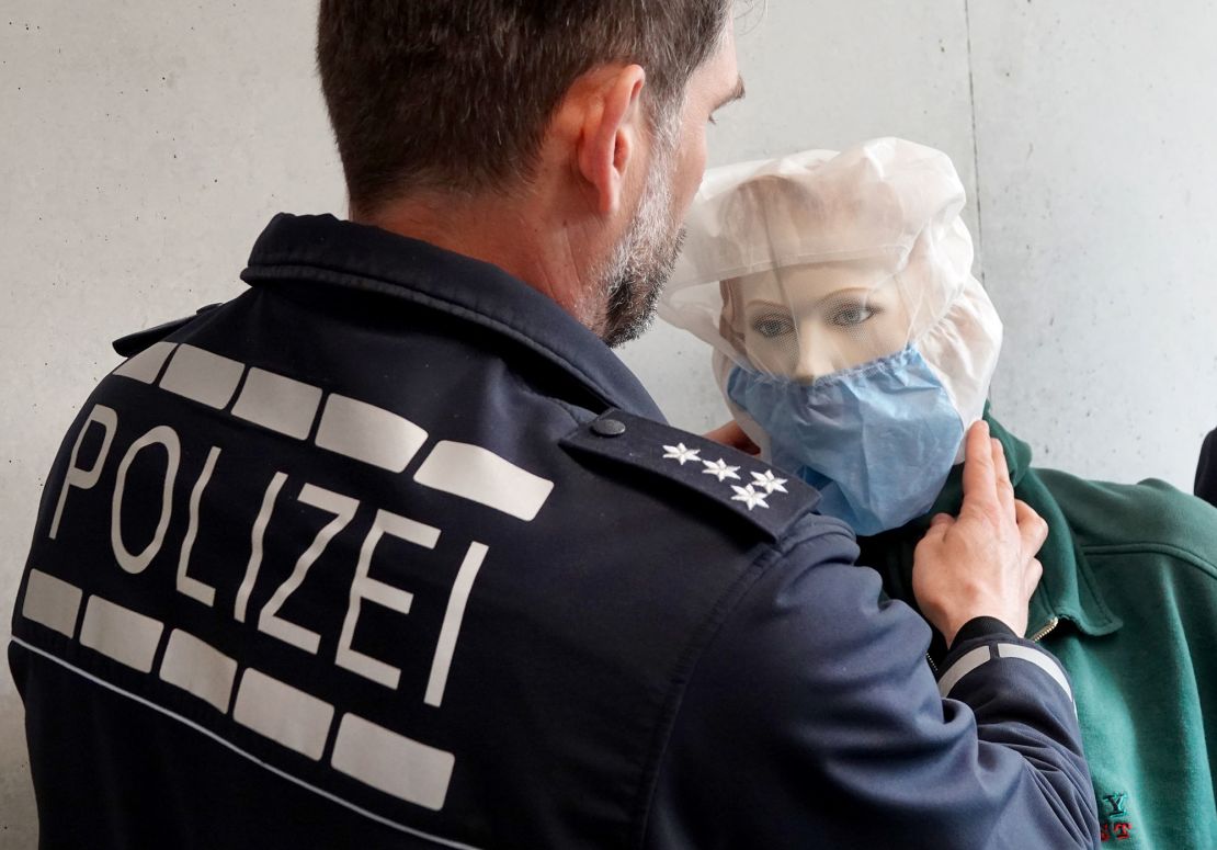 A police officer in Heilbronn, Germany, demonstrates the use of a spit hood on a dummy in April 2019.