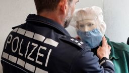 10 April 2019, Baden-Wuerttemberg, Heilbronn: The press officer of the Heilbronn police headquarters, Gerald Olma, shows the use of a spit protection hood on a doll. In view of an increasing number of spitting attacks, police officers are equipped with special protective hoods, which are put on the spitting attacker in case of emergency. Photo: Simon Sachseder/dpa (Photo by Simon Sachseder/picture alliance via Getty Images)