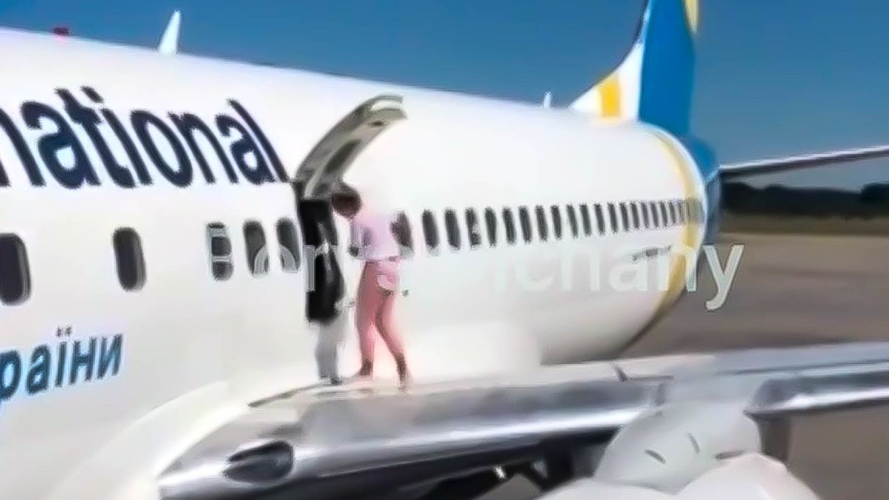 The woman was summoned back inside by the airplane's crew.