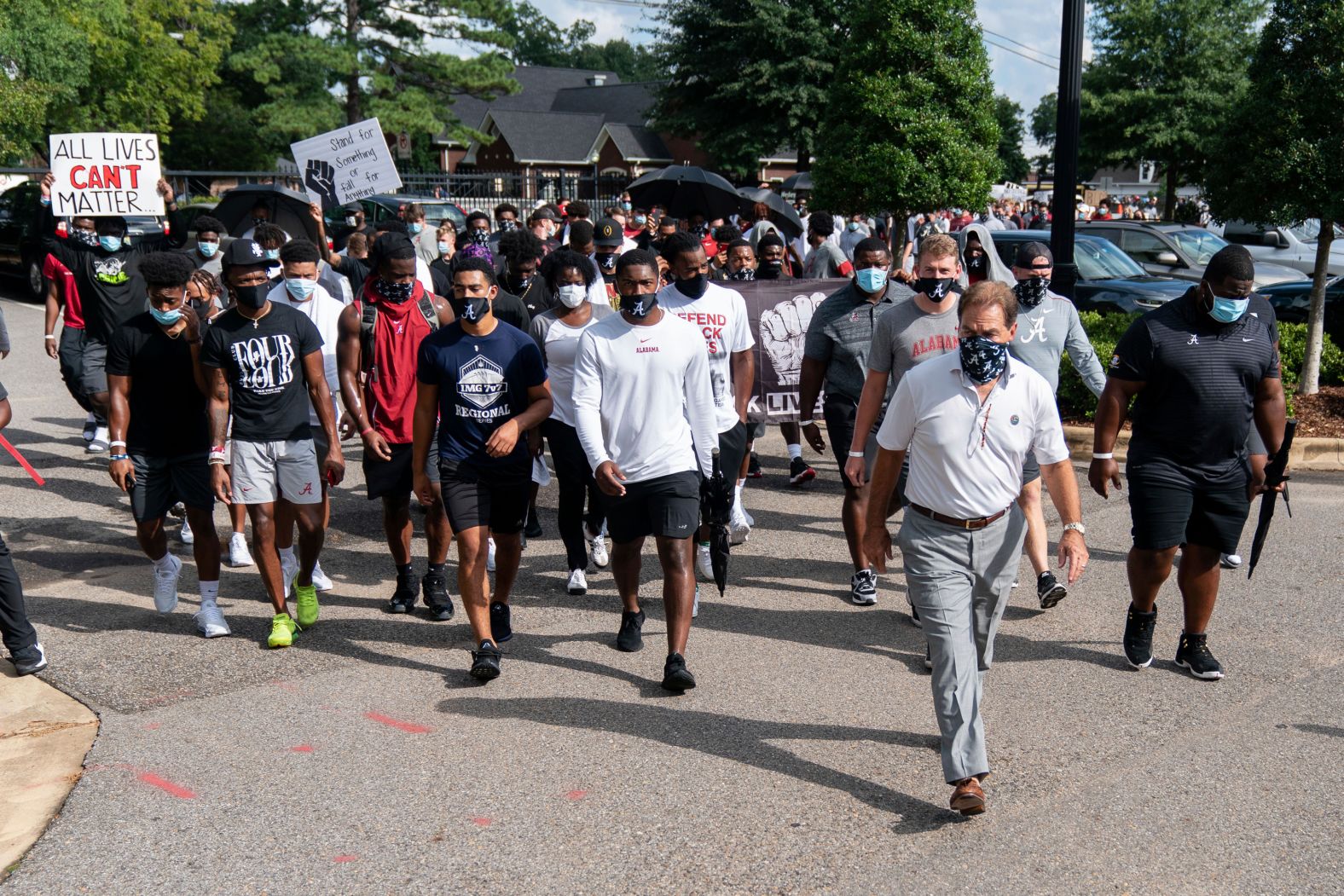 The University of Alabama football team, led by coach Nick Saban, marches on campus in support of the Black Lives Matter movement.