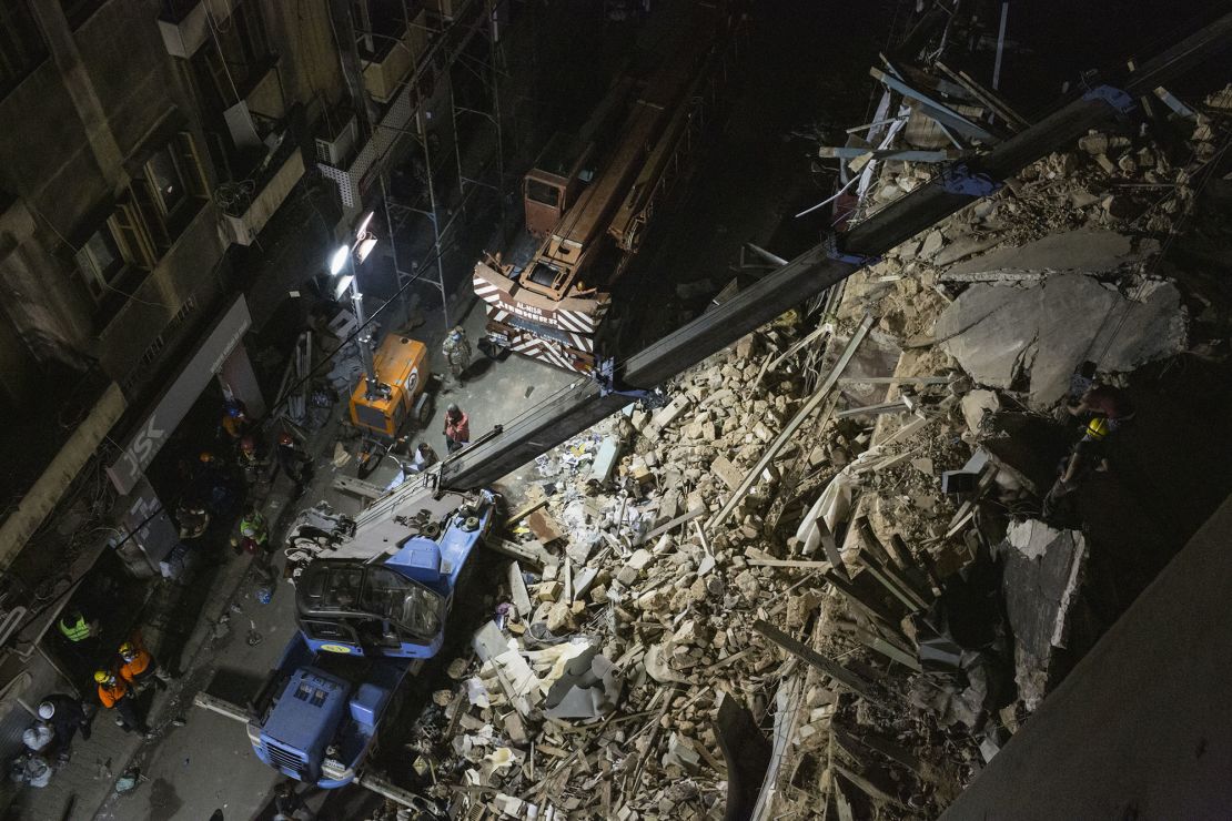 Rescue workers use a crane to lift concrete slabs from a destroyed building as they search for survivors on September 4, 2020 in Beirut.
