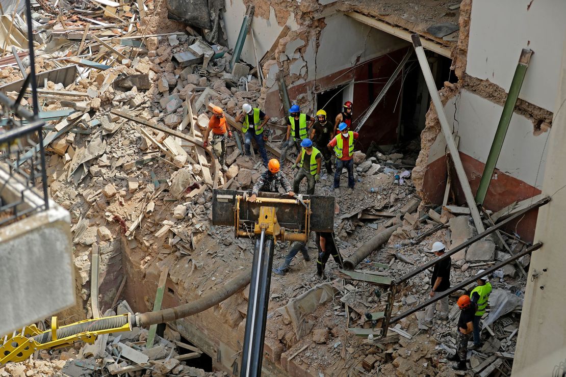 Rescue workers dig through the rubble of a badly damaged building in Lebanon's capital Beirut, in search of possible survivors.