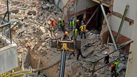 Rescue workers dig through the rubble of a badly damaged building in Lebanon's capital Beirut, in search of possible survivors.