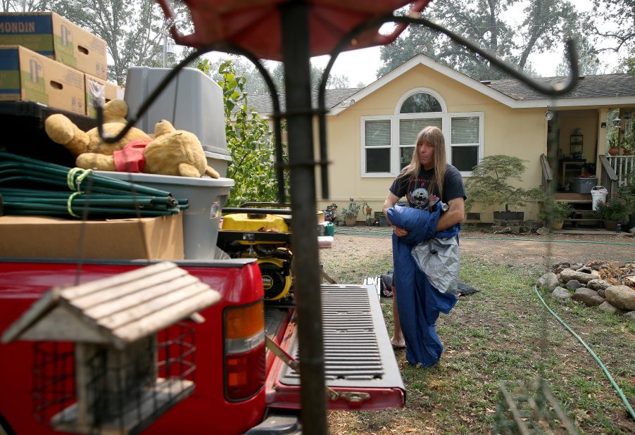 Randy Hunt packs up his belongings, including his daughter Natasha's first Pooh bear, left, in case he and his wife Sheli had to evacuate the home they rent in Middletown, California, on August 26, 2020.