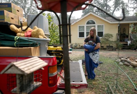 Randy Hunt packs up his belongings, including his daughter Natasha's first Pooh bear, left, in case he and his wife Sheli had to evacuate the home they rent in Middletown, California, on August 26.