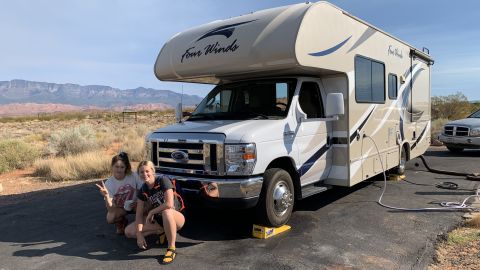 The author's daughters Shannon, right, and Chelsea Yogerst pose in front of Thor in Hurricane, Utah.