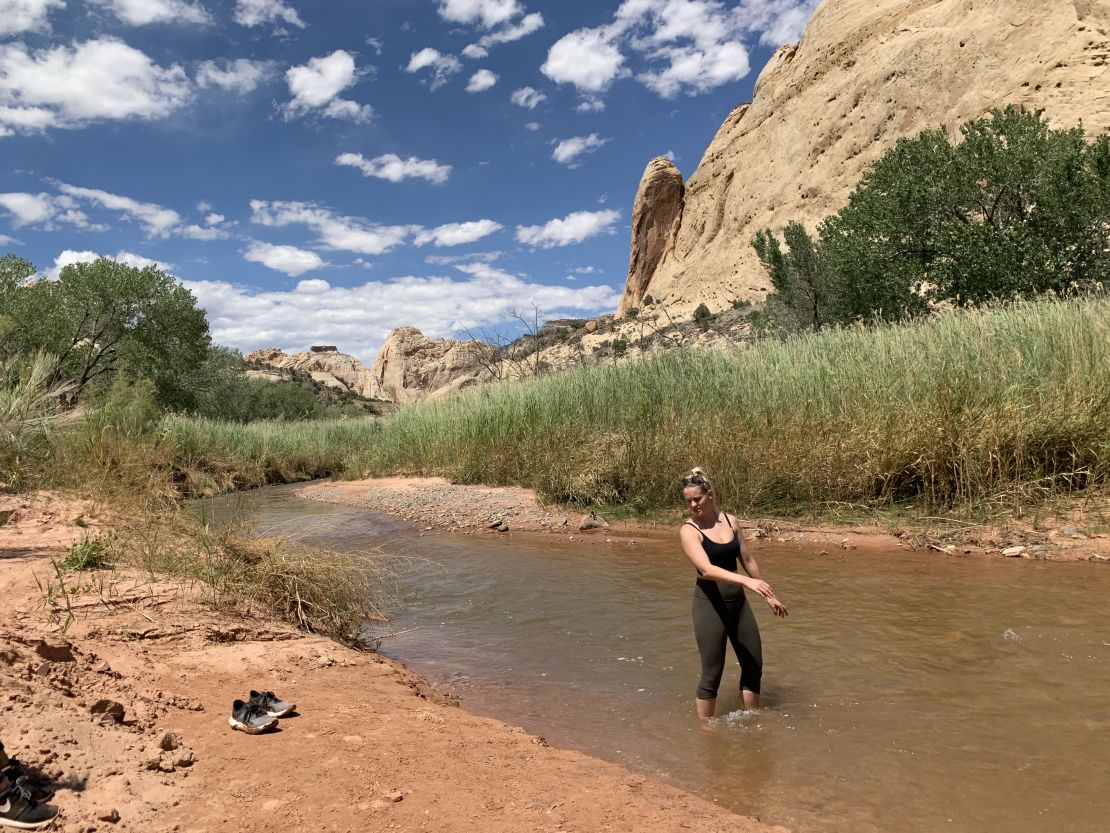 Shannon Yogerst cools off in the Fremont River after hiking the Grand Wash.