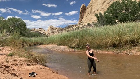 Shannon Yogerst cools off in the Fremont River after hiking the Grand Wash.