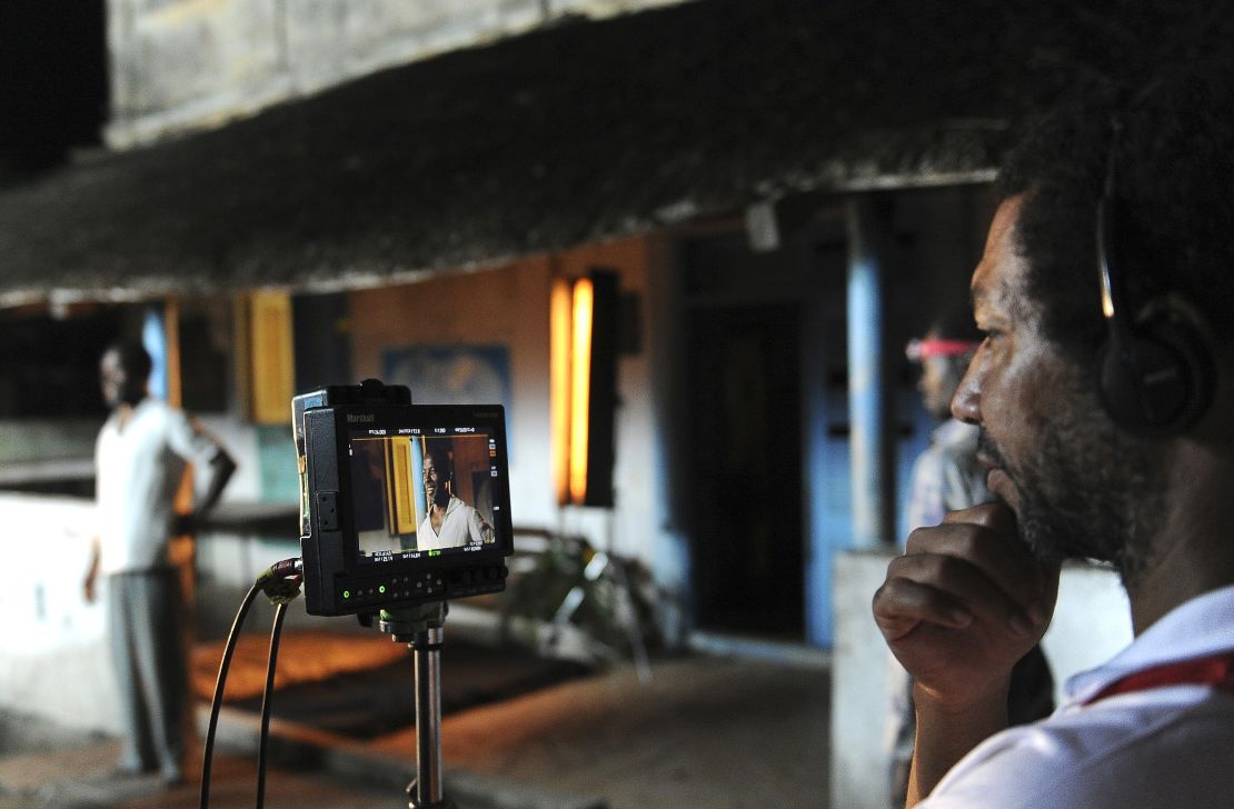 Lacôte (right) watches Ivorian actor Isaach de Bankole performing a scene from the film "Run" in 2013.