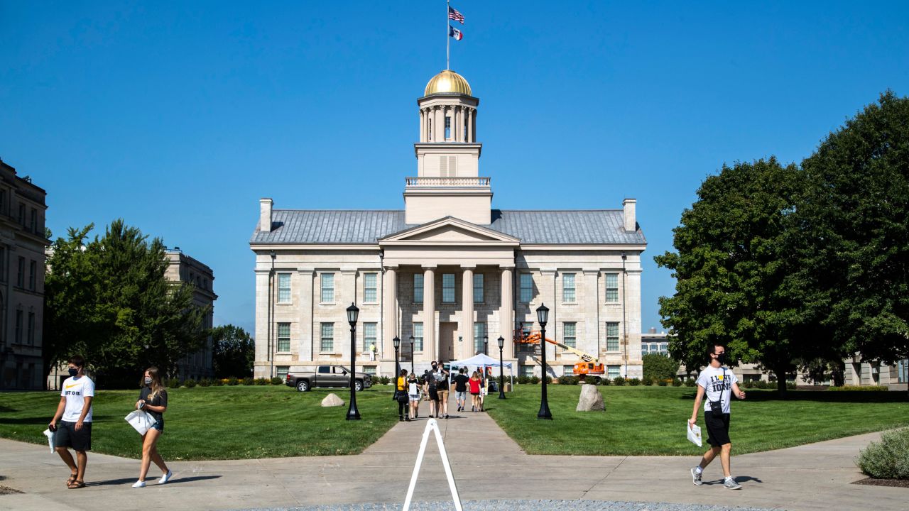 University of Iowa students walk on the Pentacrest after picking up a package of personal protective equipment (PPE) ahead of the return to classes, Friday, Aug. 14, 2020, in Iowa City, Iowa. The university is supplying each student with two reusable cloth face coverings, two disposable masks, one face shield and one small bottle of hand sanitizer.

200814 Ui Ppe Pickup 003 Jpg