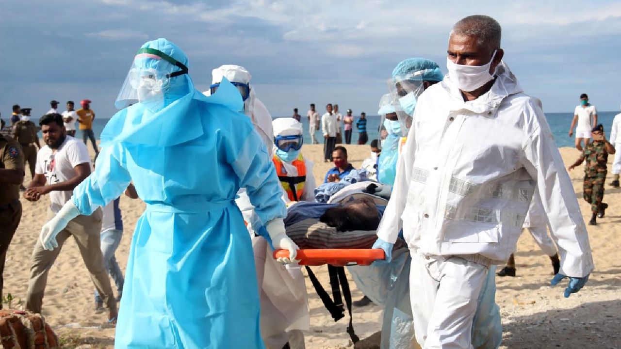 In this photo provided by Sri Lanka Navy, an injured crew member of the MT New Diamond, is transferred on stretcher to an ambulance.