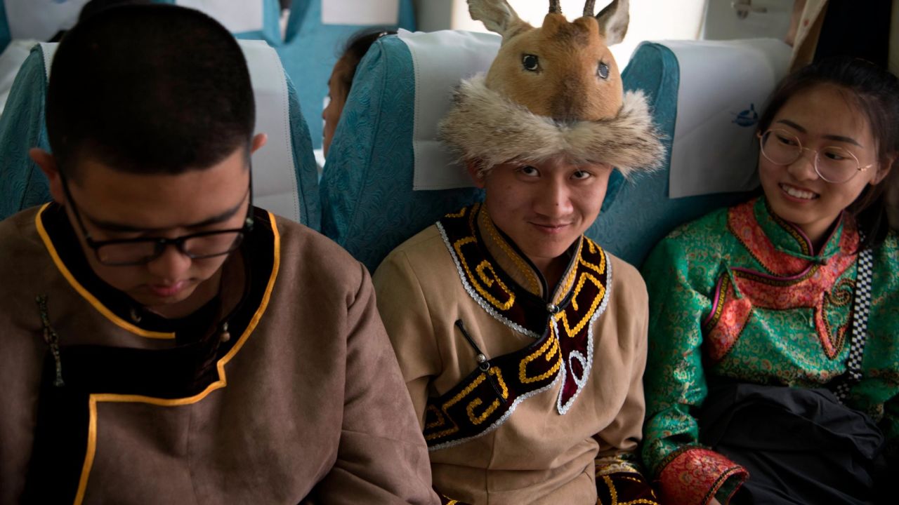 Students in traditional clothing travel on a special train to attend university entrance exam in Inner Mongolia, China in June, 2019.