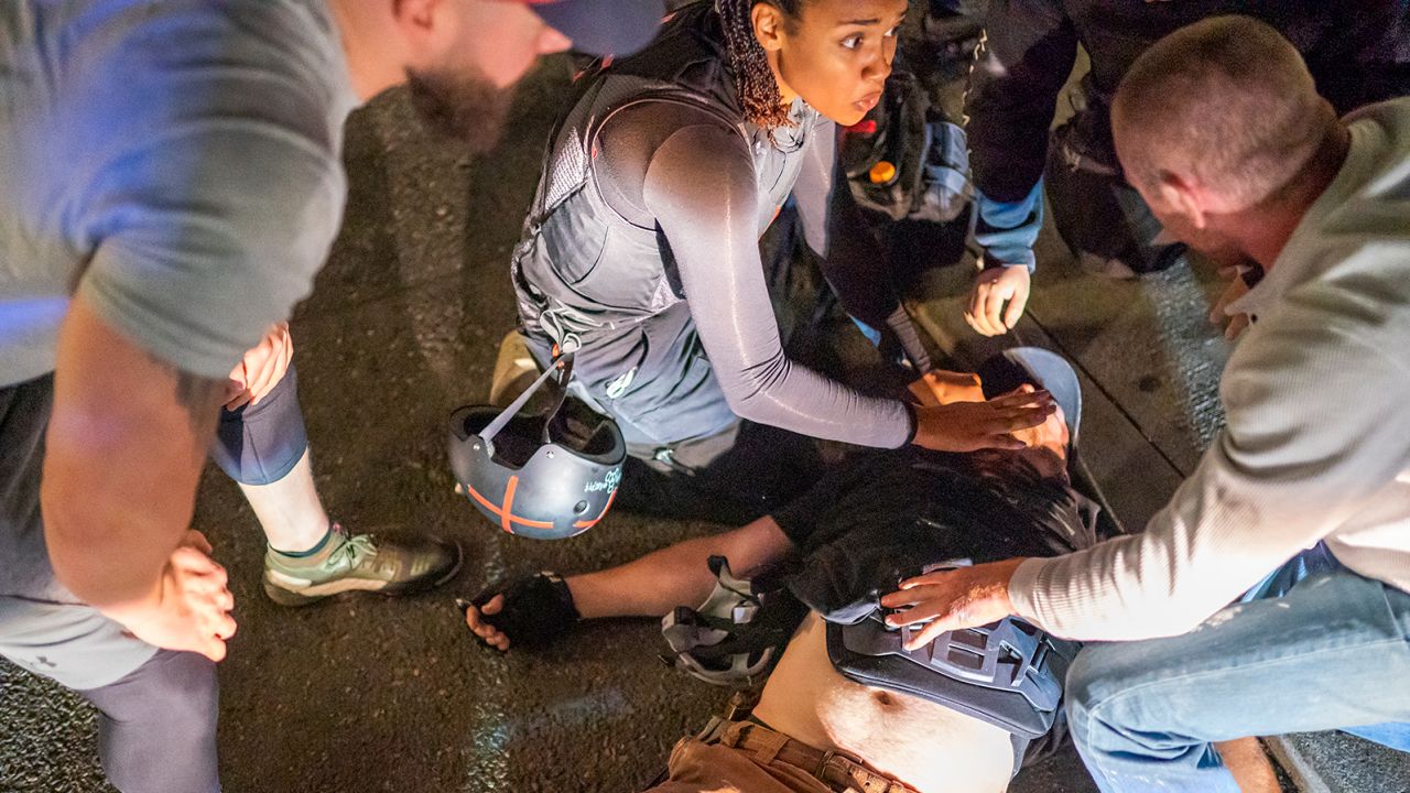 Sierra Boyne and protesters help to treat Aaron J. Danielson, who was shot near a pro-Trump rally on August 29, 2020 in Portland, Oregon.