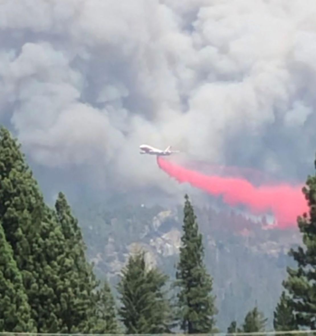 An air tanker drops fire retardant on the wildfire in the Sierra National Forest.