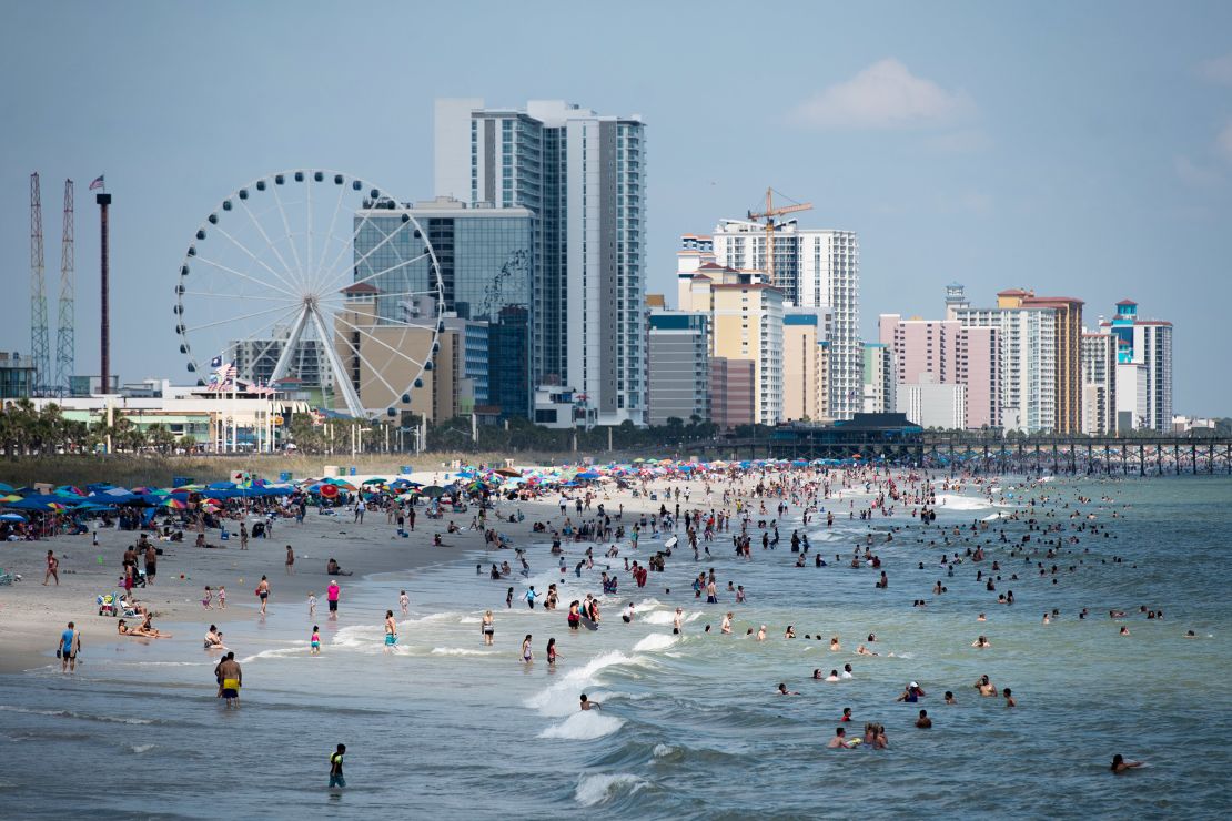 People enjoy the beach on Saturday in Myrtle Beach, South Carolina.