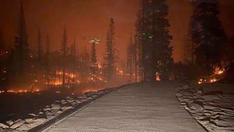The California National Guard helped rescue those trapped by a fire that blocked the only road out.