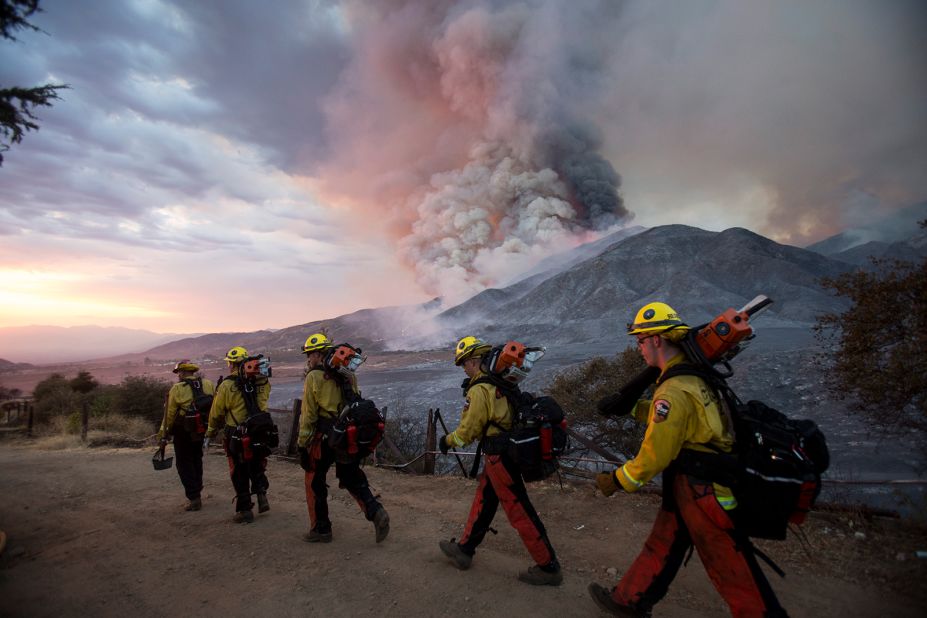 Firefighters walk in a line in Yucaipa on September 5, 2020.