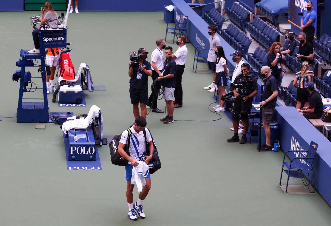 Novak Djokovic walks off court at the US Open after being defaulted. 