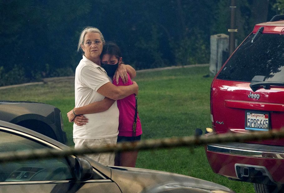 Family members comfort each other as the El Dorado Fire moves closer to their home in Yucaipa, California, on September 6, 2020.