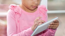 STOCK child using tablet
