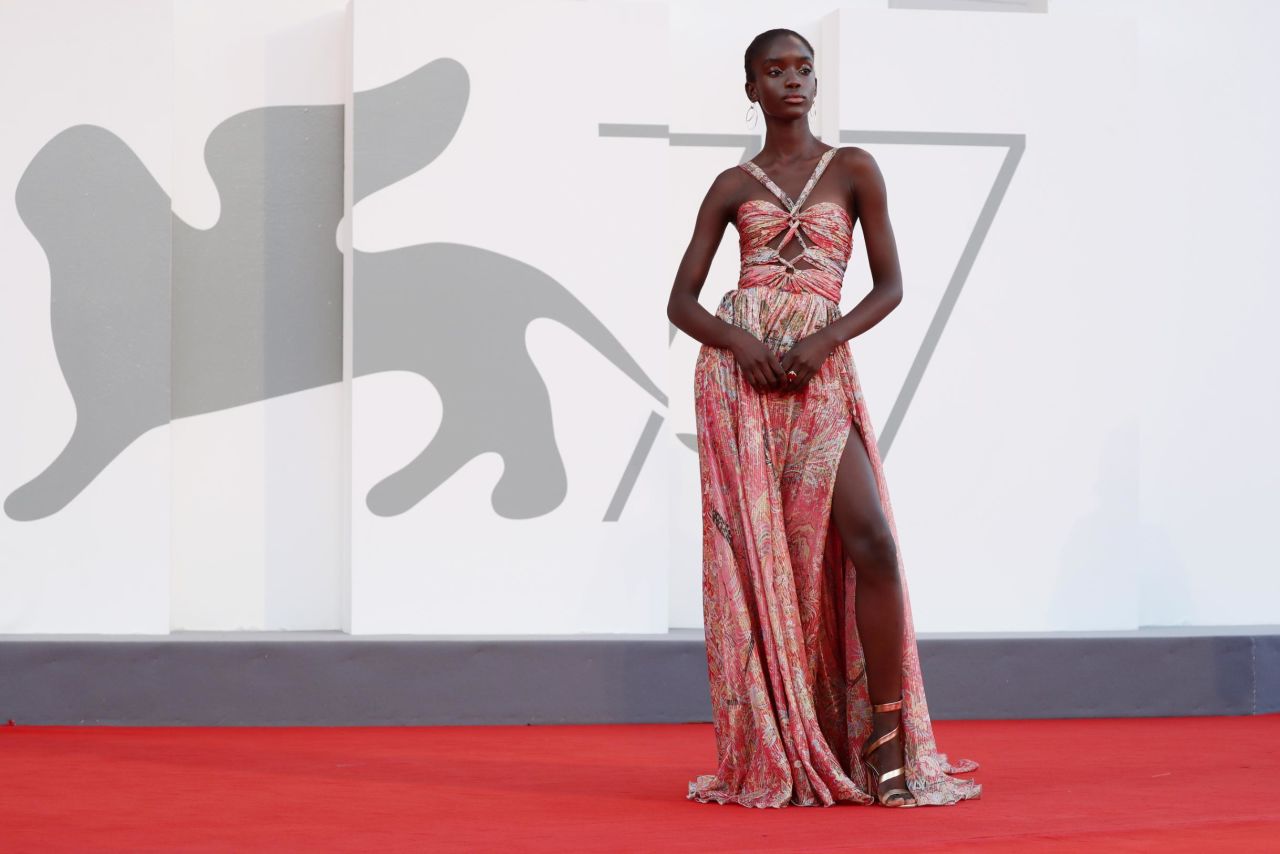 Model Maty Fall Diba arrives on the red carpet wearing a custom printed silk chiffon and golden thread Etro gown.