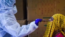 TOPSHOT - A medical representative (L) collects a swab sample from a resident for the COVID-19 coronavirus test in a residential area in Mumbai on September 7, 2020. - India overtook Brazil on September 7 as the country with the second highest number of confirmed coronavirus cases, even as key metro train lines re-opened as part of efforts to boost the South Asian nation's battered economy. (Photo by Punit PARANJPE / AFP) (Photo by PUNIT PARANJPE/AFP via Getty Images)