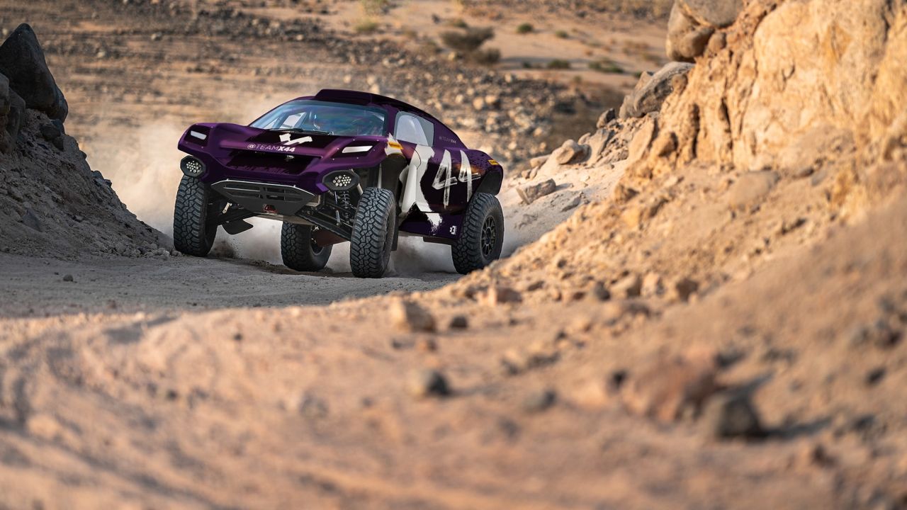 An X44 car drives on a track during Extreme E trials.