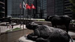 This picture taken on April 16, 2015 shows two bull statues displayed outside the stock exchange in Hong Kong.  