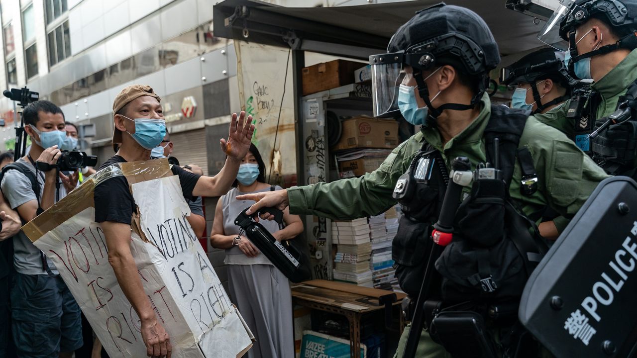 A man wearing a Voting Is A Right costome stand off with riot police during an anti-government protest on September 6, 2020 in Hong Kong, China.