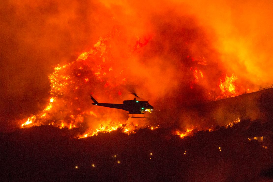 A helicopter prepares to drop water at a wildfire in Yucaipa, California, on September 5.