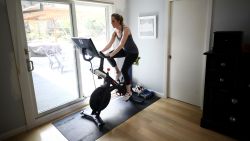 SAN ANSELMO, CALIFORNIA - APRIL 07:  Jen Van Santvoord rides her Peloton exercise bike at her home on April 07, 2020 in San Anselmo, California.  More people are turning to Peloton due shelter-in-place orders because of the coronavirus (COVID-19). The Peloton stock has continued to rise over recent weeks even as most of the stock market has plummeted. Peloton announced yesterday that they will temporarily pause all live classes until the end of April because an employee tested positive for COVID-19.  (Photo by Ezra Shaw/Getty Images)