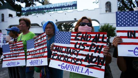 Demonstrators hold placards during a protest in front of the Department of National Defense in Manila on February 21, 2020. Members of the Gabriela Alliance for Women called for the immediate transfer of of US Marine Joseph Scott Pemberton to the National Bilibid Prison.
